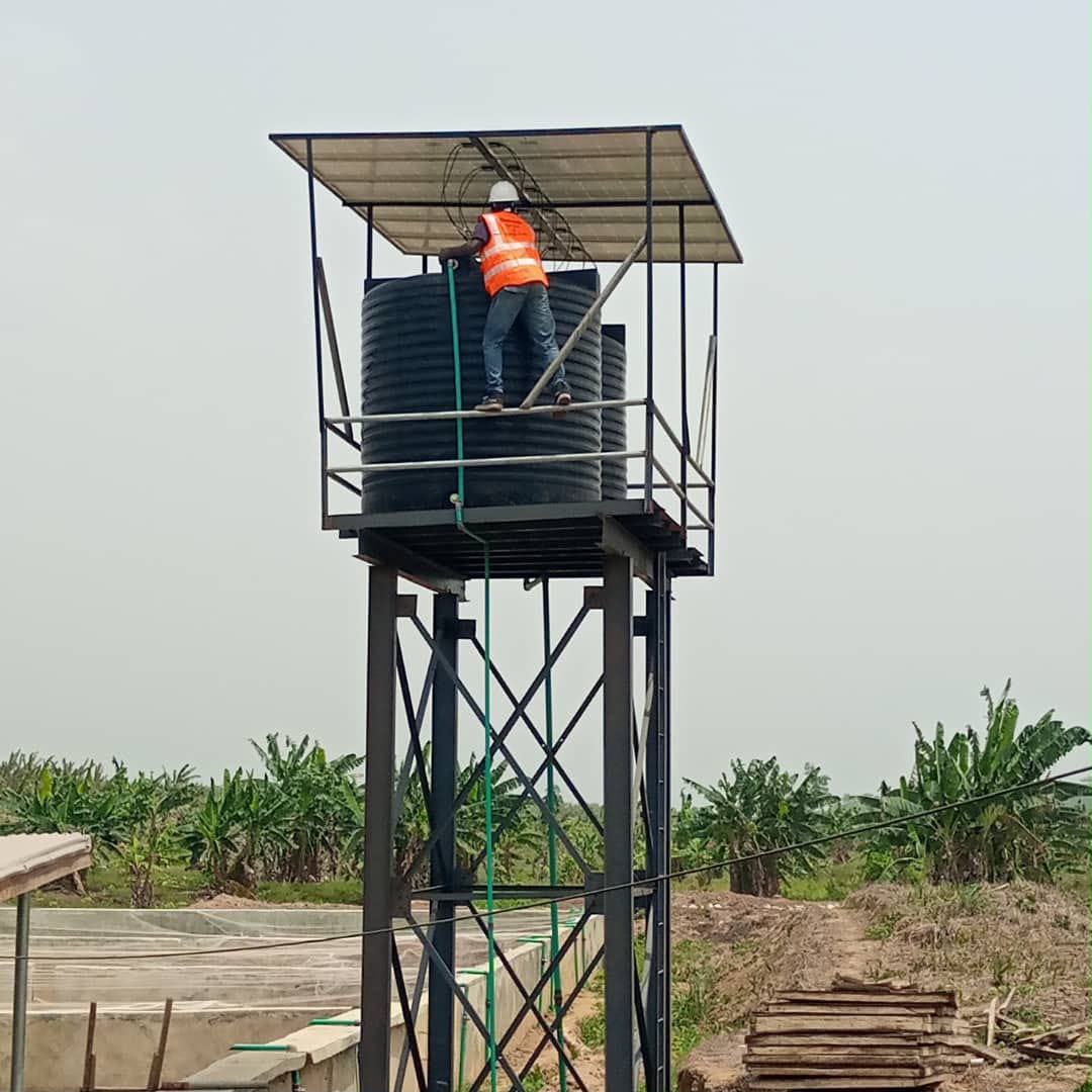 Frank and Frank technician working on a solar powered water pump installation